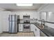 Modern kitchen with stainless steel appliances and white cabinets at 11782 W Columbine Dr, El Mirage, AZ 85335