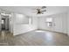 Living room with wood-look tile floor, and access to hallway at 11782 W Columbine Dr, El Mirage, AZ 85335