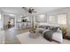 Bright living room featuring neutral tones, open layout, ceiling fan, and modern decor accents at 11782 W Columbine Dr, El Mirage, AZ 85335