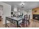 Bright dining area with rustic farmhouse table and fireplace at 1209 E Marigold Ln, Tempe, AZ 85288