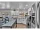 Modern kitchen with white cabinets, stainless steel appliances, and pool view at 1209 E Marigold Ln, Tempe, AZ 85288