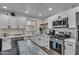 Modern kitchen with white cabinets, stainless steel appliances, and island at 1209 E Marigold Ln, Tempe, AZ 85288