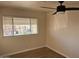 Bright bedroom with wood-look floors and ceiling fan at 13013 N 19Th Pl, Phoenix, AZ 85022