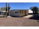 Tan mobile home with covered patio and desert landscaping at 13013 N 19Th Pl, Phoenix, AZ 85022