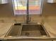 Stainless steel sink with a modern faucet and a dish rack at 13013 N 19Th Pl, Phoenix, AZ 85022