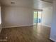 Open living space with wood-look floors and access to the patio at 13013 N 19Th Pl, Phoenix, AZ 85022