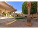 Covered patio, grassy area, and desert landscaping at 13345 W Cypress St, Goodyear, AZ 85395