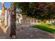 Backyard view showing a grassy area, mature trees, and a covered patio at 13345 W Cypress St, Goodyear, AZ 85395