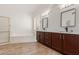 Bathroom with double vanity and dark brown cabinets at 13345 W Cypress St, Goodyear, AZ 85395