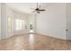 Bright bedroom with tile floors and door to backyard at 13345 W Cypress St, Goodyear, AZ 85395