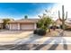 Two-car garage, desert landscaping, and a light beige exterior at 13345 W Cypress St, Goodyear, AZ 85395