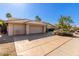 Two-car garage with large driveway and desert landscaping at 13345 W Cypress St, Goodyear, AZ 85395