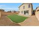 View of the exterior of the house highlighting the large yard with a green space at 13441 W Rose Ln, Litchfield Park, AZ 85340