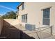 Backyard view with AC units and chain link fence at 13441 W Rose Ln, Litchfield Park, AZ 85340