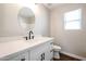 Bathroom with white vanity and black fixtures at 13441 W Rose Ln, Litchfield Park, AZ 85340