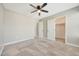 This bedroom features neutral walls, carpet flooring, a ceiling fan, and a closet at 13441 W Rose Ln, Litchfield Park, AZ 85340