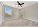 Neutral bedroom with carpet flooring, a window, and door at 13441 W Rose Ln, Litchfield Park, AZ 85340