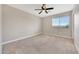 Bright bedroom with neutral carpet, paint, and natural light from window at 13441 W Rose Ln, Litchfield Park, AZ 85340