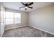 Bright bedroom with ceiling fan and carpet at 13441 W Rose Ln, Litchfield Park, AZ 85340