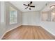 Bright bedroom with a large window, wood-look floors, and neutral paint at 13441 W Rose Ln, Litchfield Park, AZ 85340