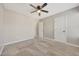 This bedroom features neutral walls, carpet flooring, a ceiling fan, and white doors at 13441 W Rose Ln, Litchfield Park, AZ 85340