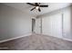 Bedroom with double door closet and ceiling fan at 13441 W Rose Ln, Litchfield Park, AZ 85340