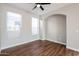 Bright bedroom with hardwood floors and ceiling fan at 13441 W Rose Ln, Litchfield Park, AZ 85340