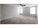 Well-lit bedroom featuring two windows and ceiling fan at 13441 W Rose Ln, Litchfield Park, AZ 85340