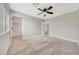 Comfortable bedroom with neutral carpet, paint, walk-in closet, and ceiling fan at 13441 W Rose Ln, Litchfield Park, AZ 85340