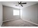 Bright bedroom with ceiling fan and carpet flooring at 13441 W Rose Ln, Litchfield Park, AZ 85340