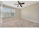 Bedroom featuring carpet flooring and a large window at 13441 W Rose Ln, Litchfield Park, AZ 85340