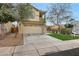 Charming two-story home features a well-manicured lawn, attached garage, and inviting facade at 13441 W Rose Ln, Litchfield Park, AZ 85340