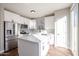 Modern kitchen with white cabinets and quartz countertops at 13441 W Rose Ln, Litchfield Park, AZ 85340