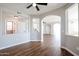 Open concept living area with hardwood floors and arches at 13441 W Rose Ln, Litchfield Park, AZ 85340