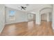 Bright living area with wood-look floors, neutral walls, and archways at 13441 W Rose Ln, Litchfield Park, AZ 85340