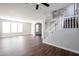 Bright living room with hardwood floors and staircase at 13441 W Rose Ln, Litchfield Park, AZ 85340