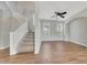 Carpeted staircase with white railing leads to second floor; neutral wall paint; ceiling fan at 13441 W Rose Ln, Litchfield Park, AZ 85340