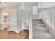 Carpeted staircase with white railing and a view of the adjacent half bathroom at 13441 W Rose Ln, Litchfield Park, AZ 85340