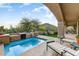 Relaxing backyard oasis featuring a sparkling pool, comfortable seating, and mountain views at 13462 E Wethersfield Rd, Scottsdale, AZ 85259