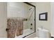 Clean bathroom with tub shower combo and a toilet at 13462 E Wethersfield Rd, Scottsdale, AZ 85259