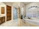 Luxurious bathroom with soaking tub, walk-in shower, and double vanity at 13462 E Wethersfield Rd, Scottsdale, AZ 85259