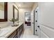 Double vanity bathroom with access to a bedroom at 13462 E Wethersfield Rd, Scottsdale, AZ 85259