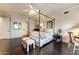 Bright bedroom with a four-poster bed and dark wood floors at 13462 E Wethersfield Rd, Scottsdale, AZ 85259