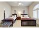 Bright bedroom featuring two twin beds and a ceiling fan at 13462 E Wethersfield Rd, Scottsdale, AZ 85259