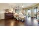 Main bedroom with a four-poster bed and dark wood floors at 13462 E Wethersfield Rd, Scottsdale, AZ 85259