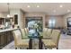 Elegant dining area with a glass table and seating for eight at 13462 E Wethersfield Rd, Scottsdale, AZ 85259