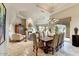 Formal dining room with large table, comfortable chairs, and a view to the living room at 13462 E Wethersfield Rd, Scottsdale, AZ 85259