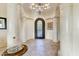 Grand entryway with high ceilings, elegant chandelier, and ornate columns at 13462 E Wethersfield Rd, Scottsdale, AZ 85259