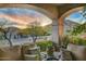 Relaxing patio seating area with sunset mountain views at 13462 E Wethersfield Rd, Scottsdale, AZ 85259