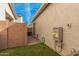 Small backyard with artificial turf and gas lines at 14104 W Bronco Trl, Surprise, AZ 85387